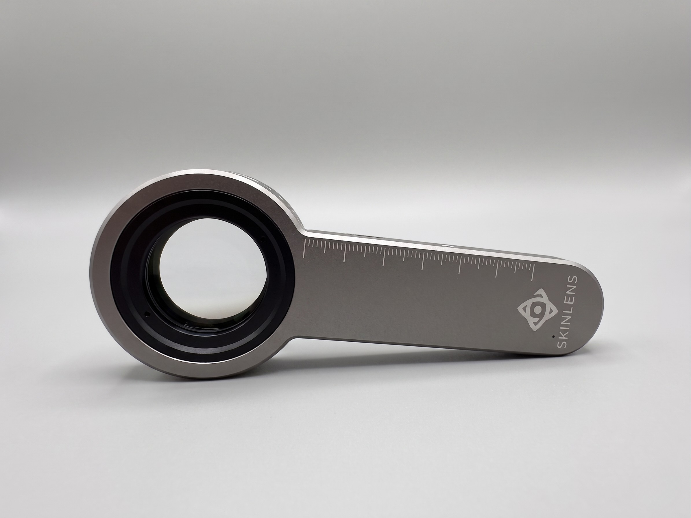 Top view of SkinLens Pro dermatoscope showing large diameter optical glass