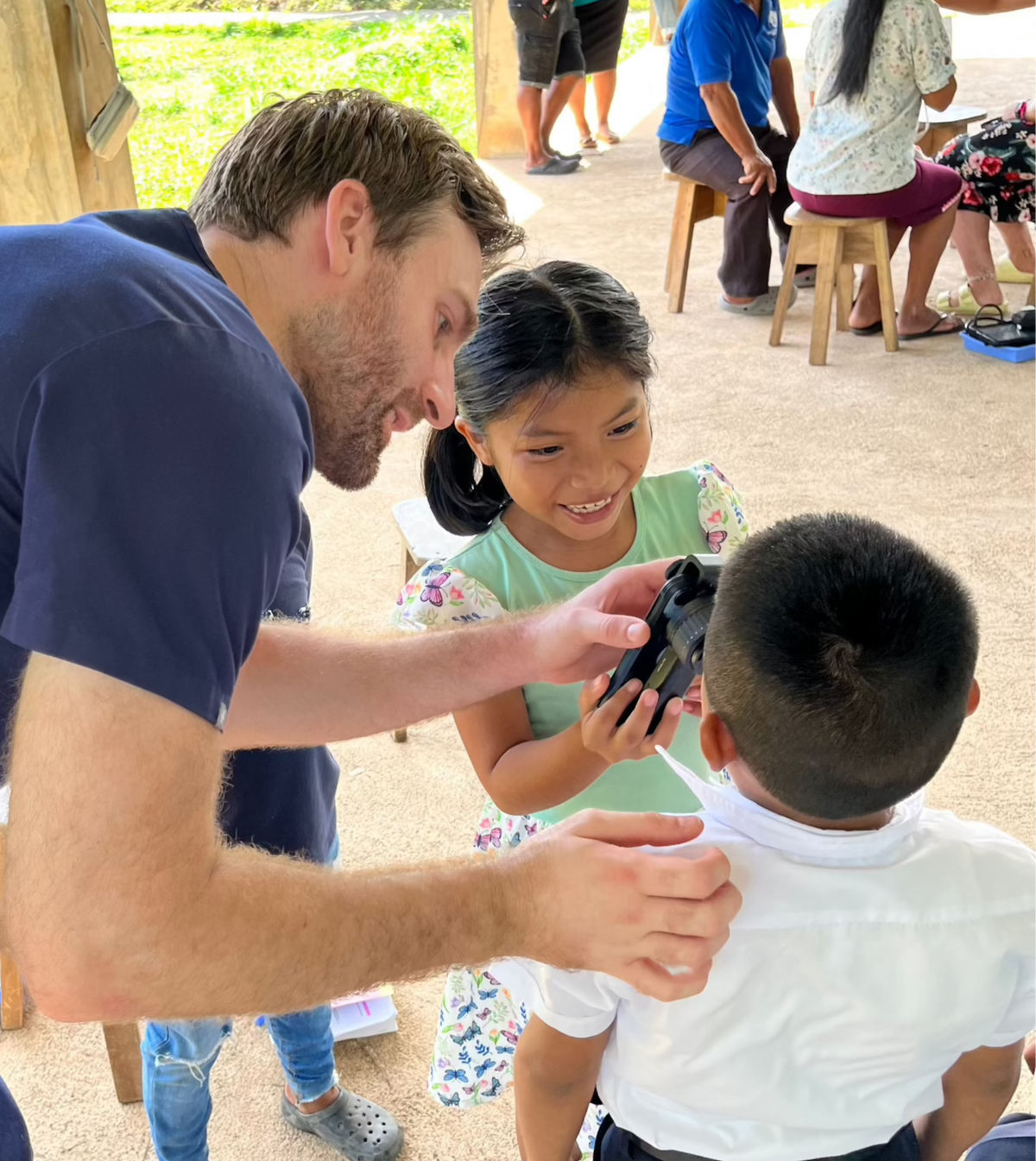 Dermatologist teaching kids how to use dermatoscope
